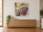 Vineyard Bottle and Grapes floral canvas print on the wall of a living room above a sideboard