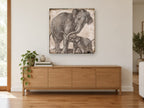 Elephant Mother and Calf animal canvas print on the wall of a living room above a sideboard