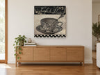 Café de Paris Teacup vintage canvas print on the wall of a living room above a sideboard