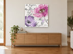 Pink and Lilac Script Poppies floral canvas print on the wall of a living room above a sideboard