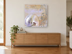 Pearl Nautilus Plage coastal canvas print on the wall of a living room above a sideboard