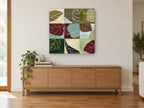 Leaf Patchwork Grid floral canvas print on the wall of a living room above a sideboard