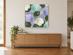 Hydrangea Postcard Lavenders floral canvas print on the wall of a living room above a sideboard