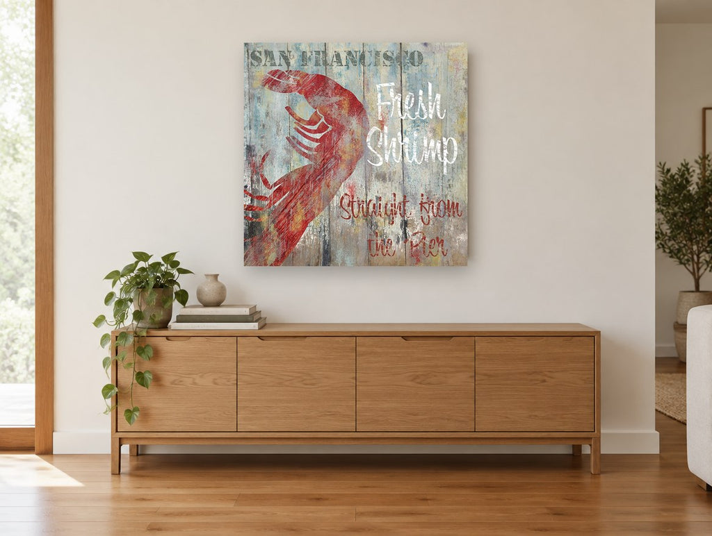 Fresh Shrimp Pier Sign coastal canvas print on the wall of a living room above a sideboard