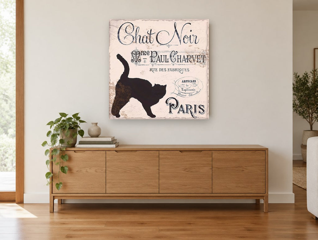 Chat Noir Paris Sign animal canvas print on the wall of a living room above a sideboard
