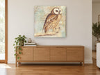 Letter Script Owl animal canvas print on the wall of a living room above a sideboard