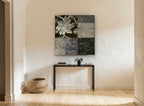 Love Is The Answer Patchwork floral canvas print on the wall of a hallway