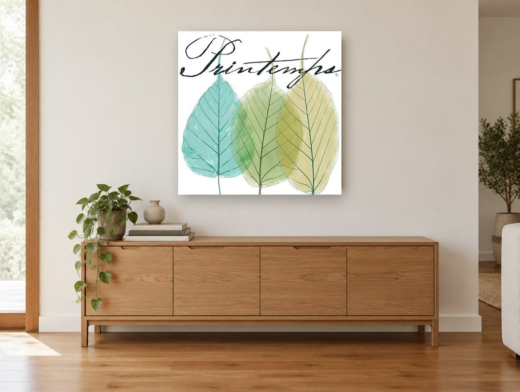 Three Leaves Printemps floral canvas print on the wall of a living room above a sideboard