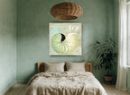 Green Nautilus Shell coastal canvas print on the wall of a bedroom