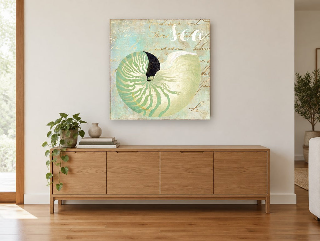 Green Nautilus Shell coastal canvas print on the wall of a living room above a sideboard