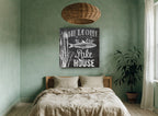 Chalkboard Lake House Welcome landscape canvas print on the wall of a bedroom