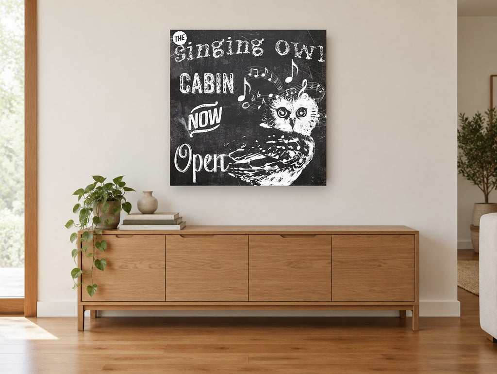 Singing Owl Cabin animal canvas print on the wall of a living room above a sideboard