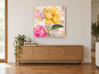 Yellow Peony French Ephemera floral canvas print on the wall of a living room above a sideboard
