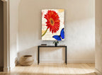 Red Gerbera and Blue Butterfly floral canvas print on the wall of a hallway