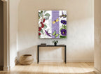 Cherries and Hummingbirds floral canvas print on the wall of a hallway