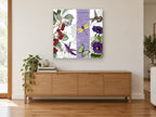 Cherries and Hummingbirds floral canvas print on the wall of a living room above a sideboard