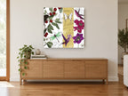 Cherries and Hummingbirds floral canvas print on the wall of a living room above a sideboard