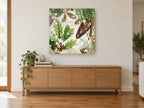 Snowy Oak and Pine floral canvas print on the wall of a living room above a sideboard