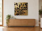 Olive Branch Gilt Silhouette floral canvas print on the wall of a living room above a sideboard