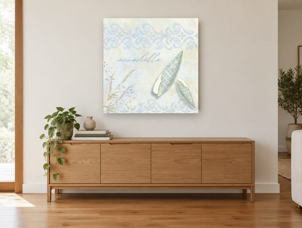 Pale Spindle Shells coastal canvas print on the wall of a living room above a sideboard