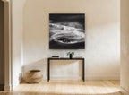 Rock in Swirling Surf coastal canvas print on the wall of a hallway
