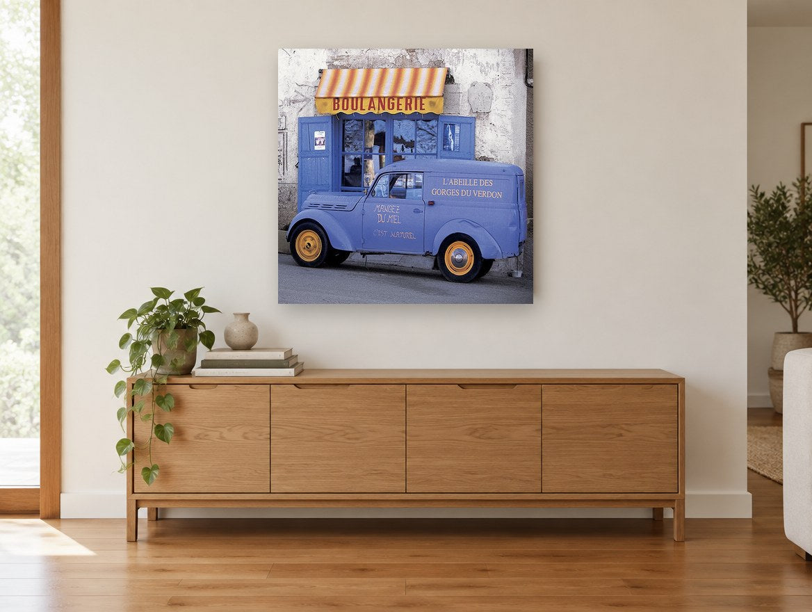 Honey Van Boulangerie vintage canvas print on the wall of a living room above a sideboard