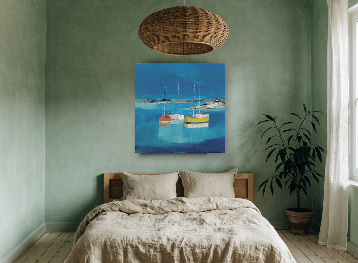 Three Boats at Rest coastal canvas print on the wall of a bedroom