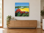 Poppies Above Yellow Fields landscape canvas print on the wall of a living room above a sideboard