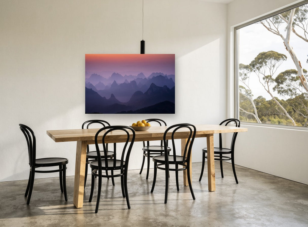 Layered Peaks at Dawn landscape canvas print on the wall of a dining room