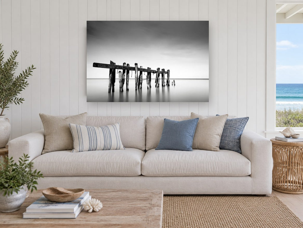 Weathered Jetty Stillness landscape canvas print on the wall of a beach house living room