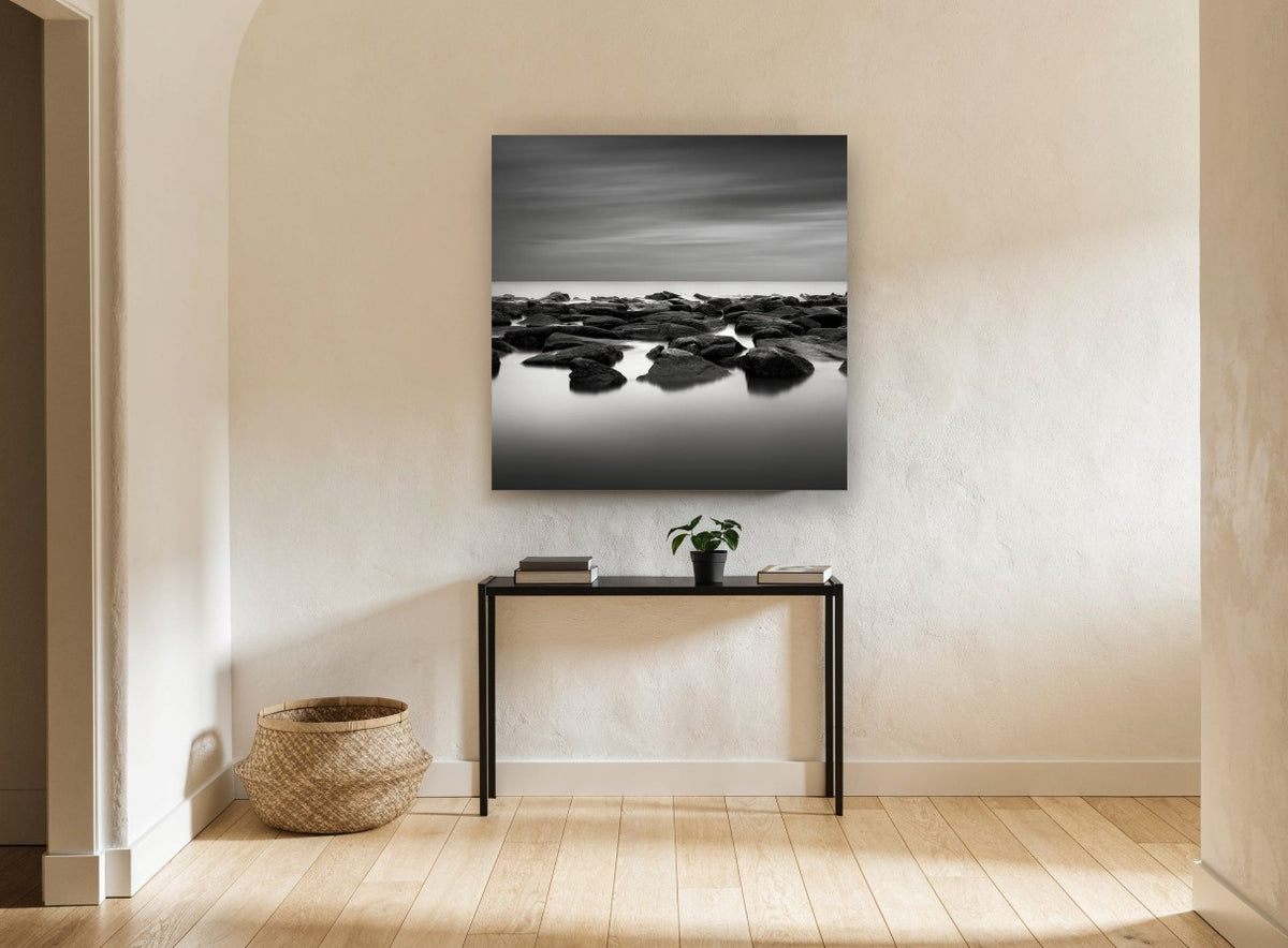 Still Water Rocks coastal canvas print on the wall of a hallway