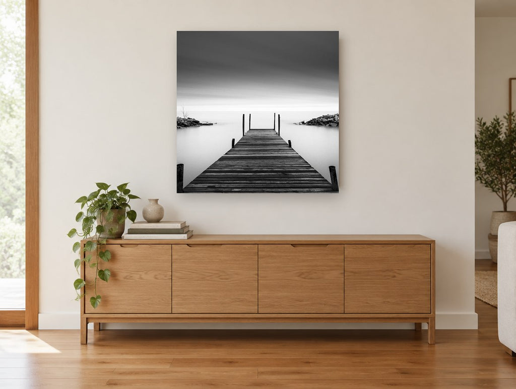 Still Water Jetty coastal canvas print on the wall of a living room above a sideboard