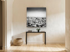 Pebble Shore Stillness coastal canvas print on the wall of a hallway