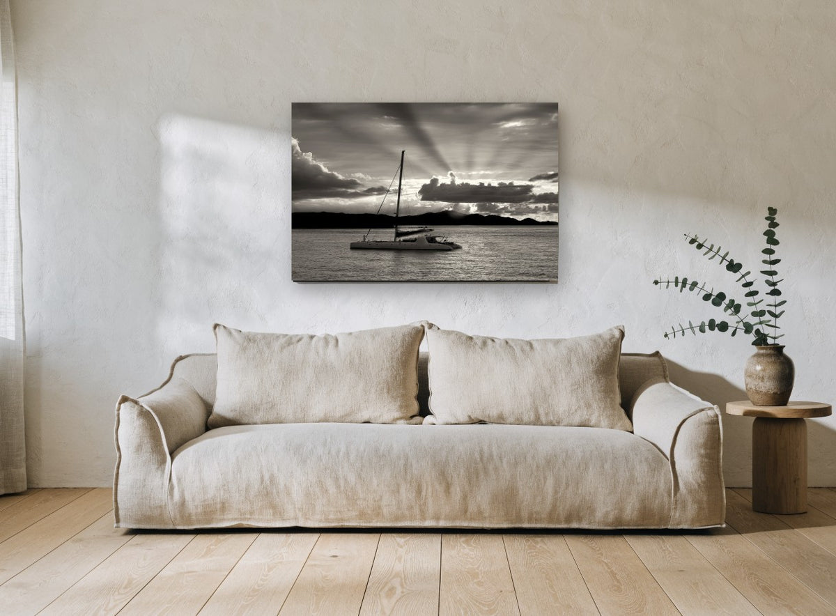 Catamaran at Dusk coastal canvas print on the wall of a living room
