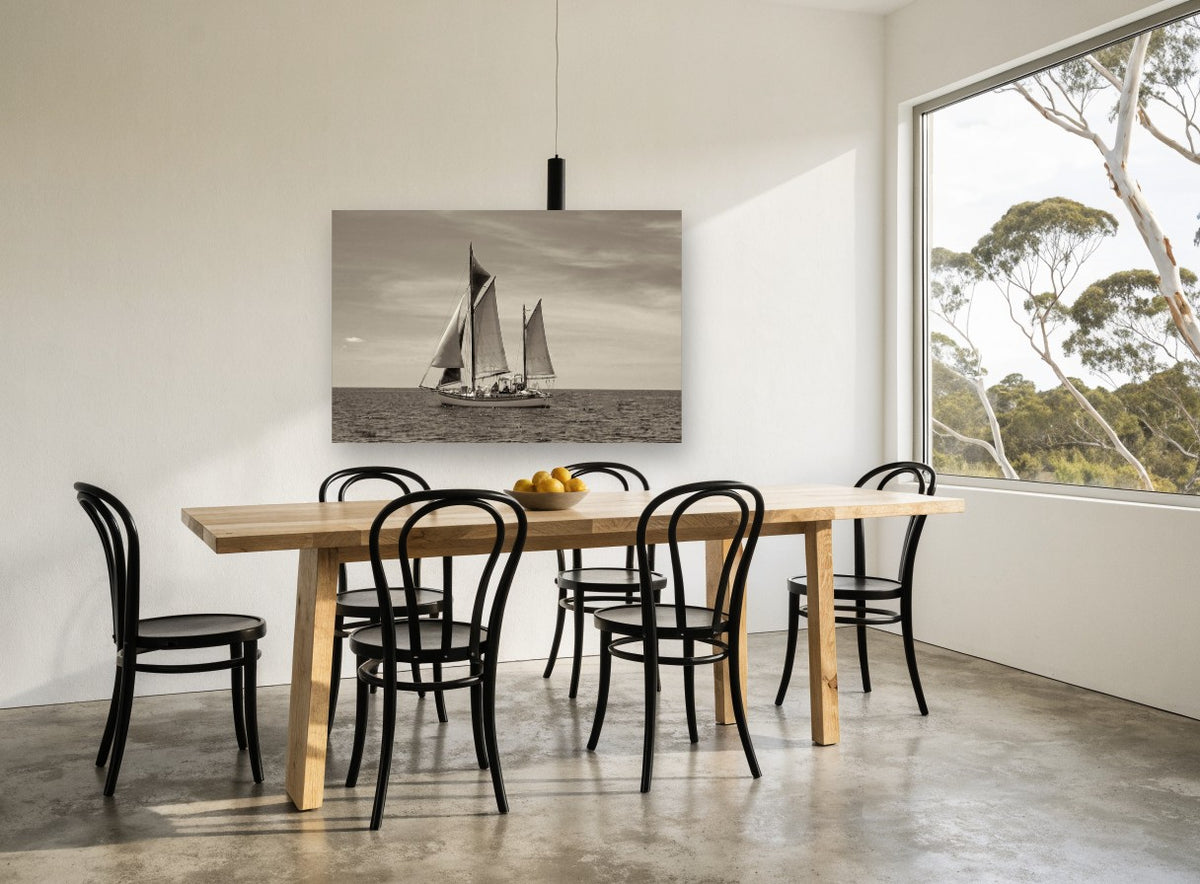 Ketch on Quiet Water coastal canvas print on the wall of a dining room