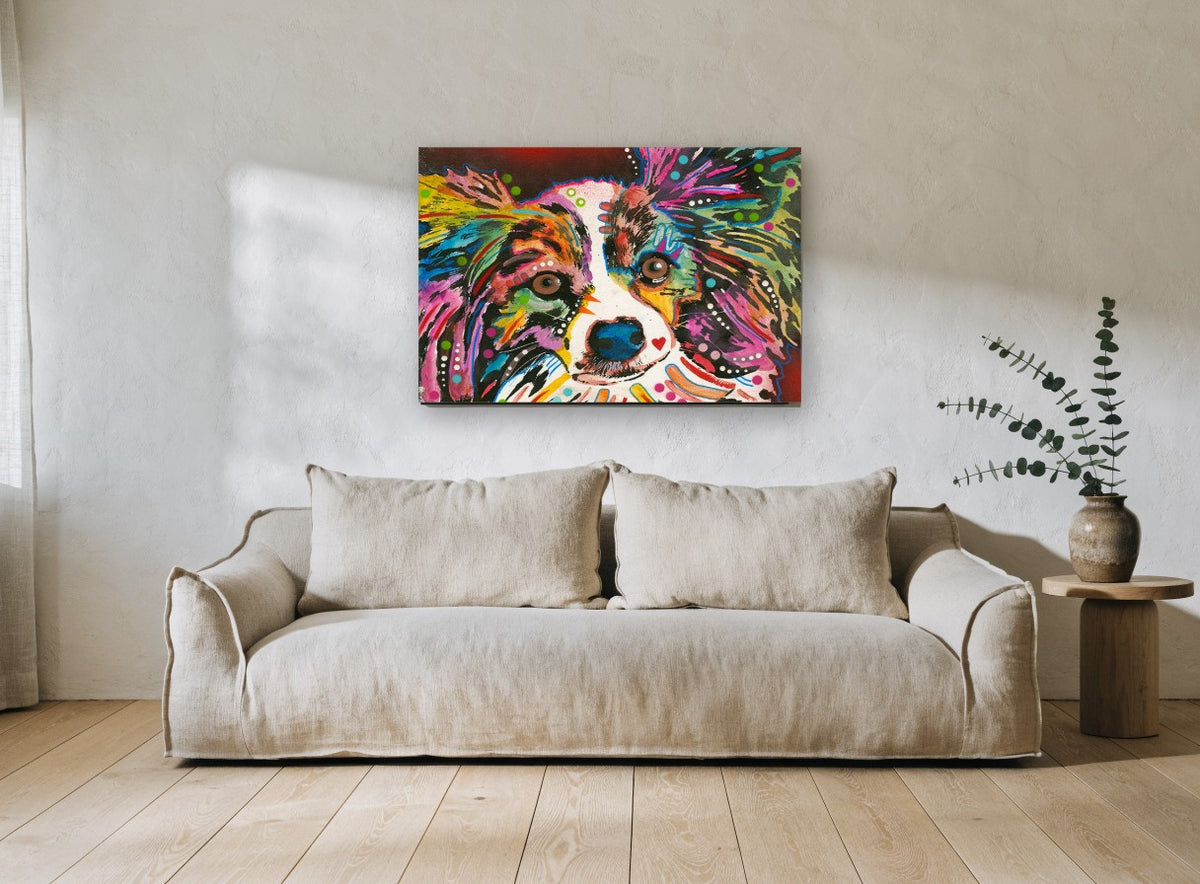 Rainbow Papillon Stare animal canvas print on the wall of a living room