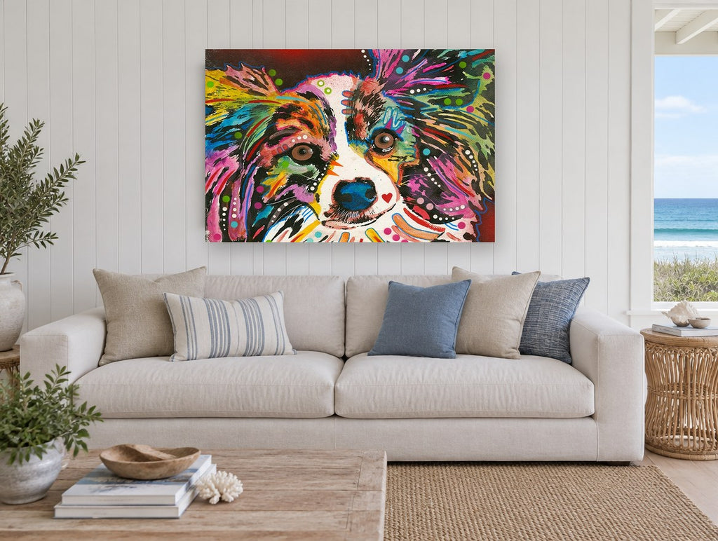 Rainbow Papillon Stare animal canvas print on the wall of a beach house living room