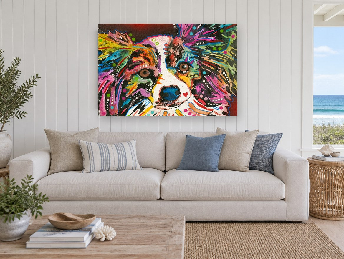 Rainbow Papillon Stare animal canvas print on the wall of a beach house living room