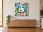 Bright Border Collie animal canvas print on the wall of a living room above a sideboard