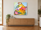 Tilted Head Rainbow Staffy animal canvas print on the wall of a living room above a sideboard