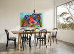 Tilted Head Rainbow Pup animal canvas print on the wall of a dining room