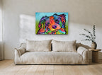 Tilted Head Rainbow Pup animal canvas print on the wall of a living room