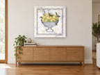 Green Apples in Silver floral canvas print on the wall of a living room above a sideboard