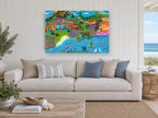 Island Village Sailboats coastal canvas print on the wall of a beach house living room