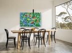 Blue Bird in Patchwork Leaves floral canvas print on the wall of a dining room