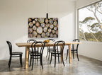 Stacked Log Ends landscape canvas print on the wall of a dining room