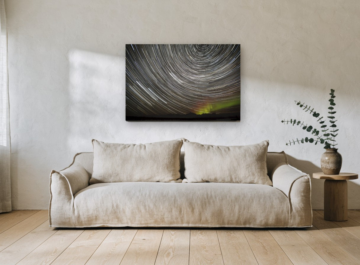 Circling Star Trails landscape canvas print on the wall of a living room