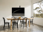 Moon Phases Over Sea coastal canvas print on the wall of a dining room