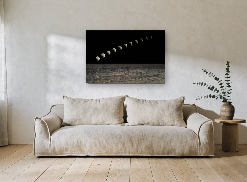 Moon Phases Over Sea coastal canvas print on the wall of a living room