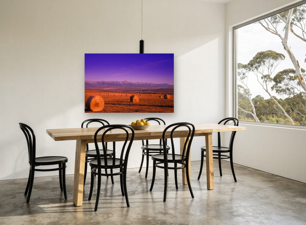 Purple Dusk Hay Bales landscape canvas print on the wall of a dining room